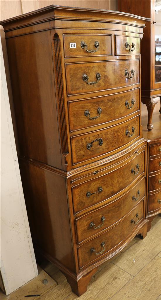 A crossbanded walnut serpentine chest on chest, W.72cm H.152cm